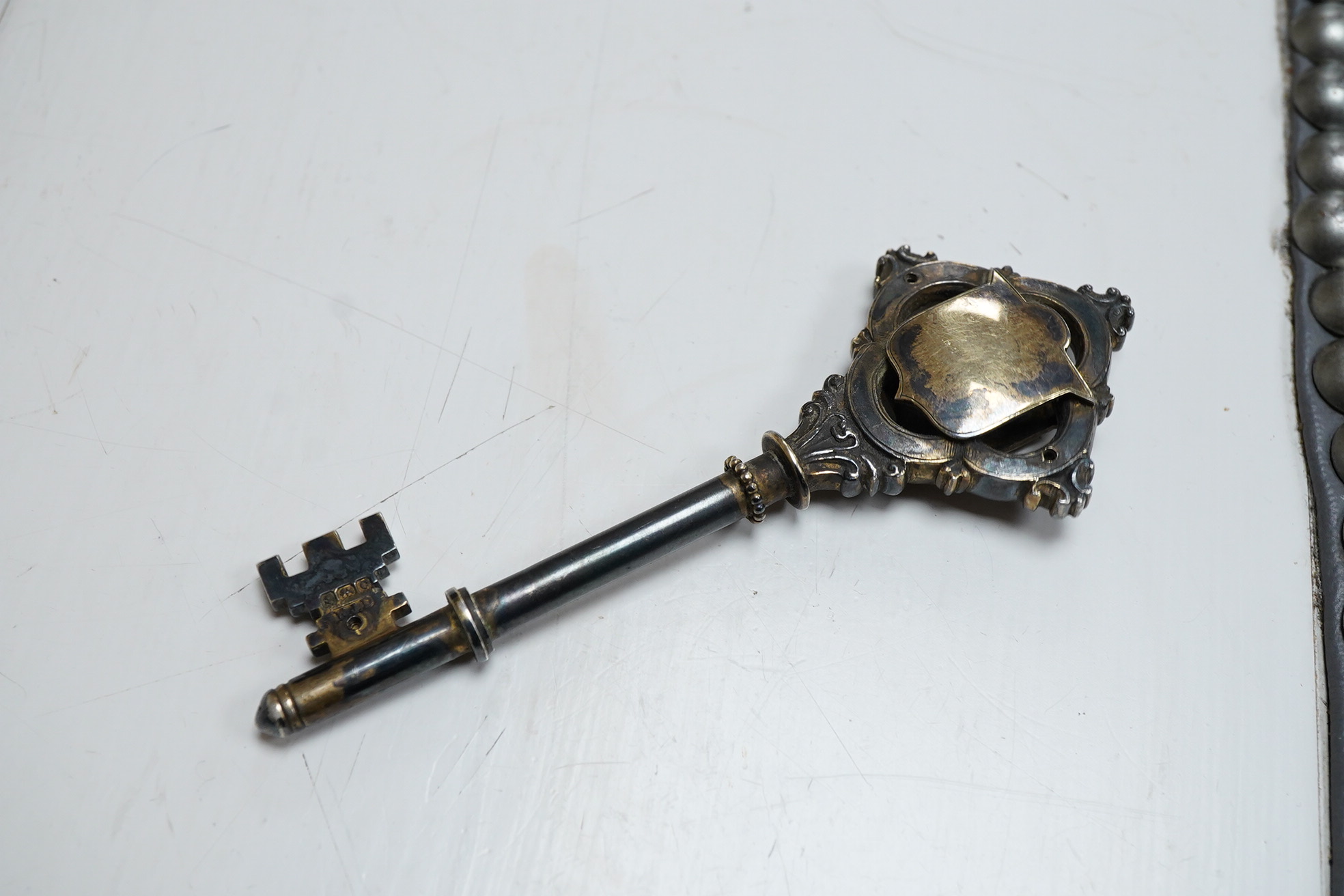 A George V silver presentation? key, engraved with the crest depicting a seated Bishop with mitre above, William James Dingley, Birmingham, 1927, 10.2cm.